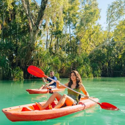 Couple kayaking along the green hued Lawn Hill Creek